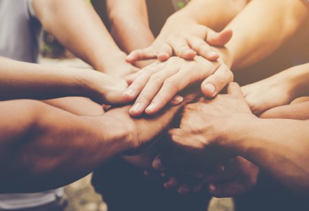 Stack of hands connecting people